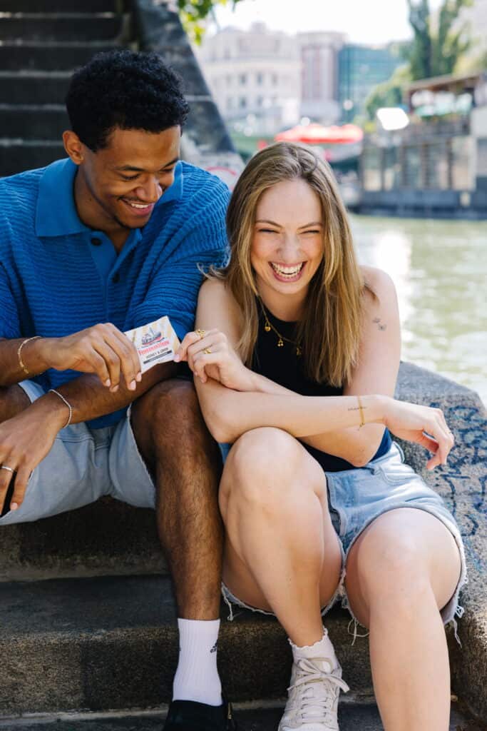 Copyright Chiara Hammerer. Two friends laughing and enjoying time by the water.