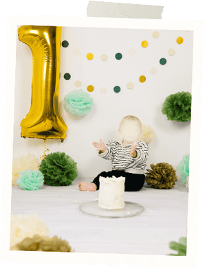 Copyright Chiara Hammerer. Child celebrating birthday with cake, balloons, and decorations.